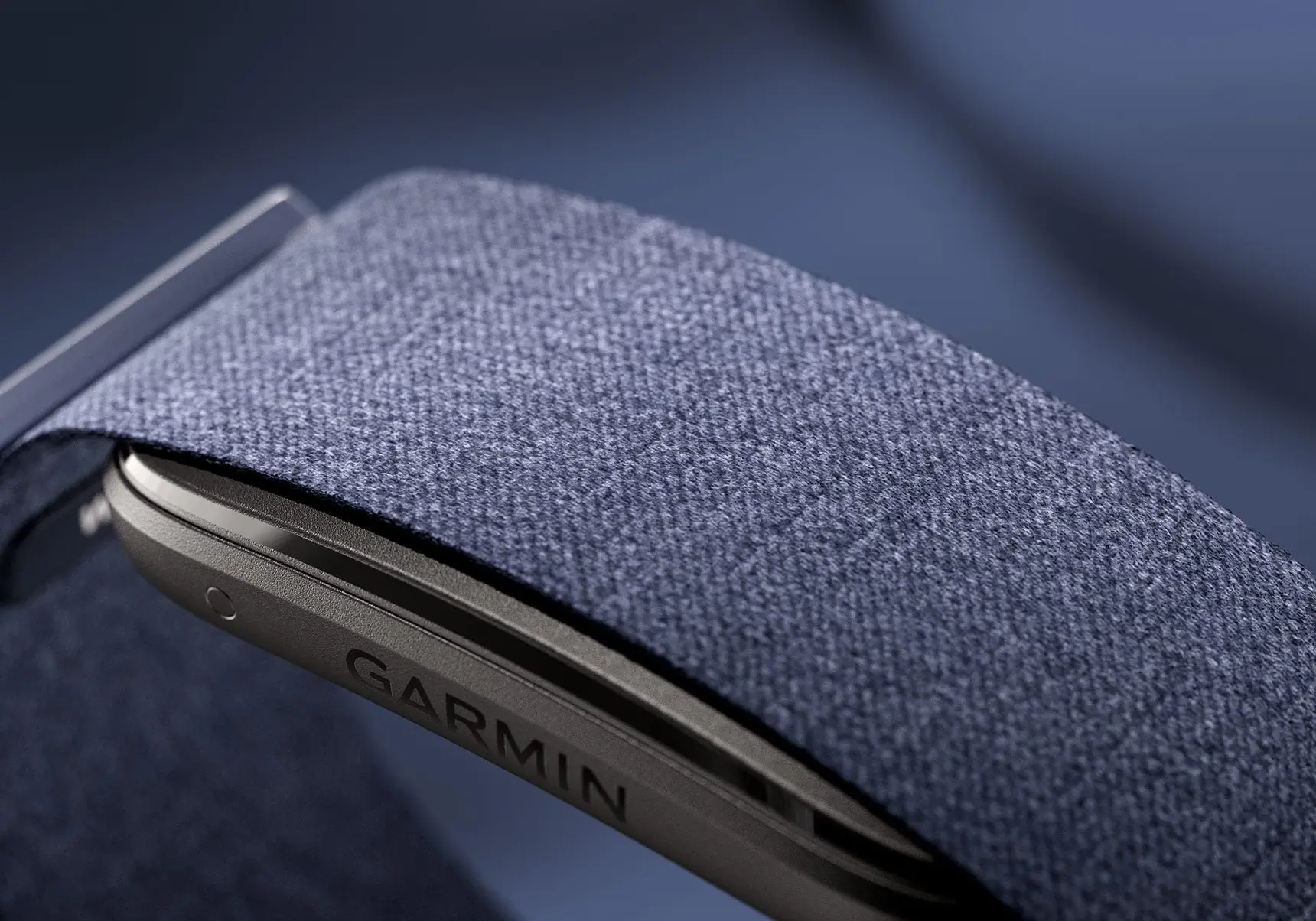 Фитнес-браслет Garmin с тканевым ремешком. Крупный план корпуса с лог
